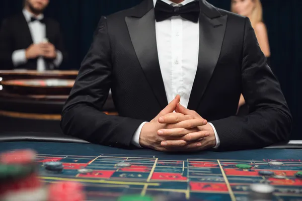 JILI7979 — A high-class gaming experience without limits A woman in a luxurious green gown next to an ornate roulette wheel, capturing the upscale casino mood of JILI7979.