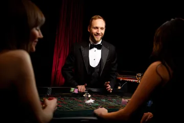 JILI7979 Mobile Casino — Play anytime, anywhere A player using their smartphone during a festive local event, representing JILI7979’s fully mobile-friendly casino.